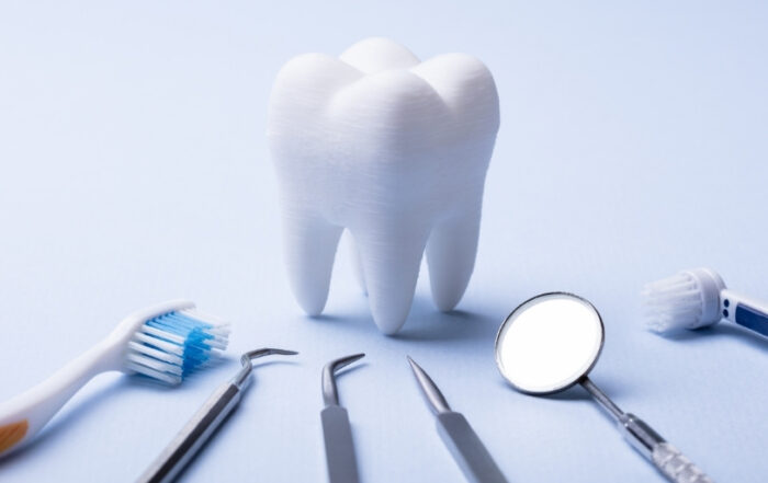 How does dental insurance work? A model tooth with dental tools at Brighter Smiles Family Dentistry in West Des Moines, IA, representing quality dental care